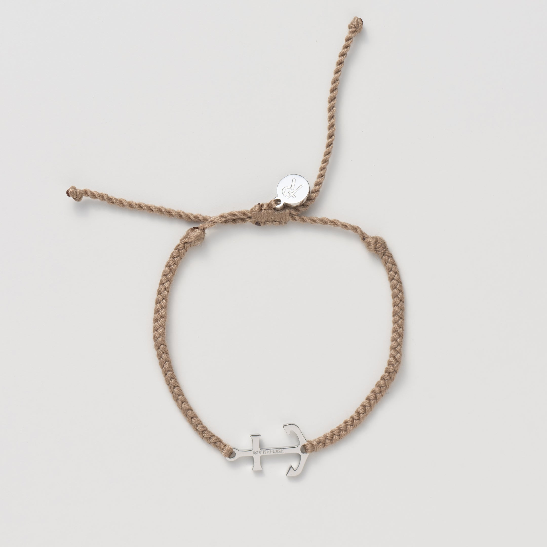 Silver anchor set on a khaki friendship bracelet with the engraving MY REFUGE from the Made4Ministry collection by Rizen Jewelry.