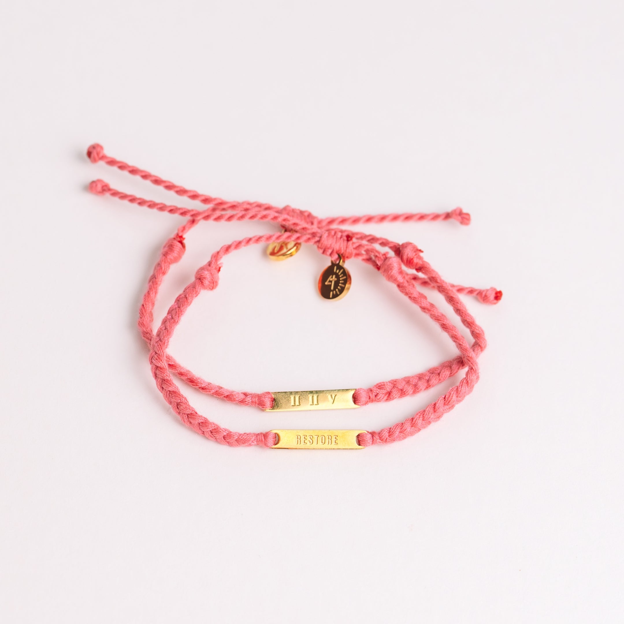 Restore Made4Ministry pink dusty rose cord bracelet x Britt Nicole from her new album IIV featuring the verse Joel 2:25. The gold bar pendant is engraved RESTORE on the front and IIV on the back. 
