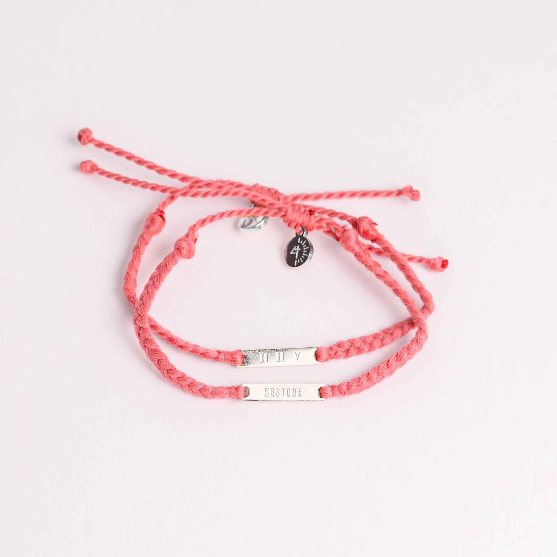 Restore Made4Ministry pink dusty rose cord bracelet x Britt Nicole from her new album IIV featuring the verse Joel 2:25. The gold bar pendant is engraved RESTORE on the front and IIV on the back. 