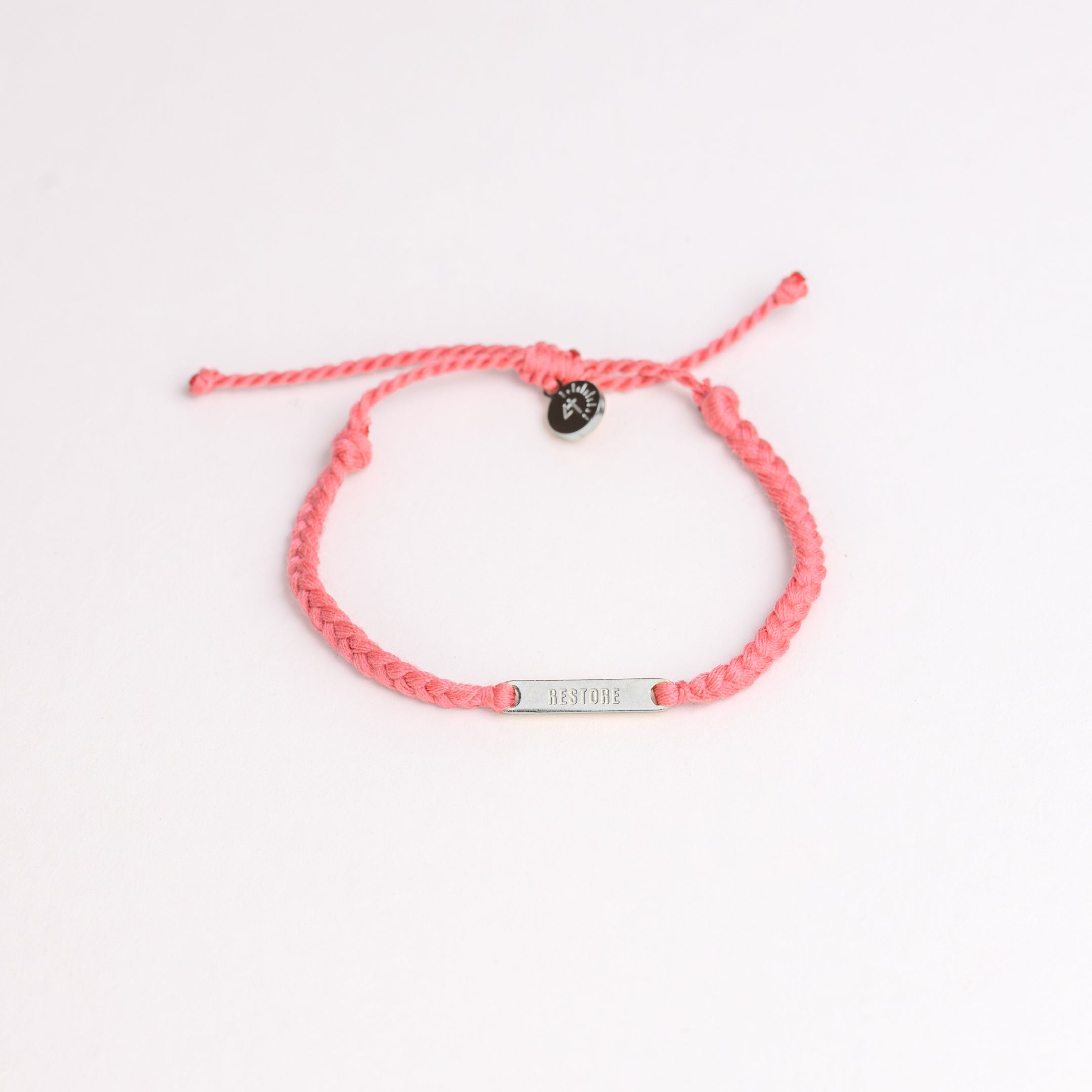 Restore Made4Ministry pink dusty rose cord bracelet x Britt Nicole from her new album IIV featuring the verse Joel 2:25. The gold bar pendant is engraved RESTORE on the front. 