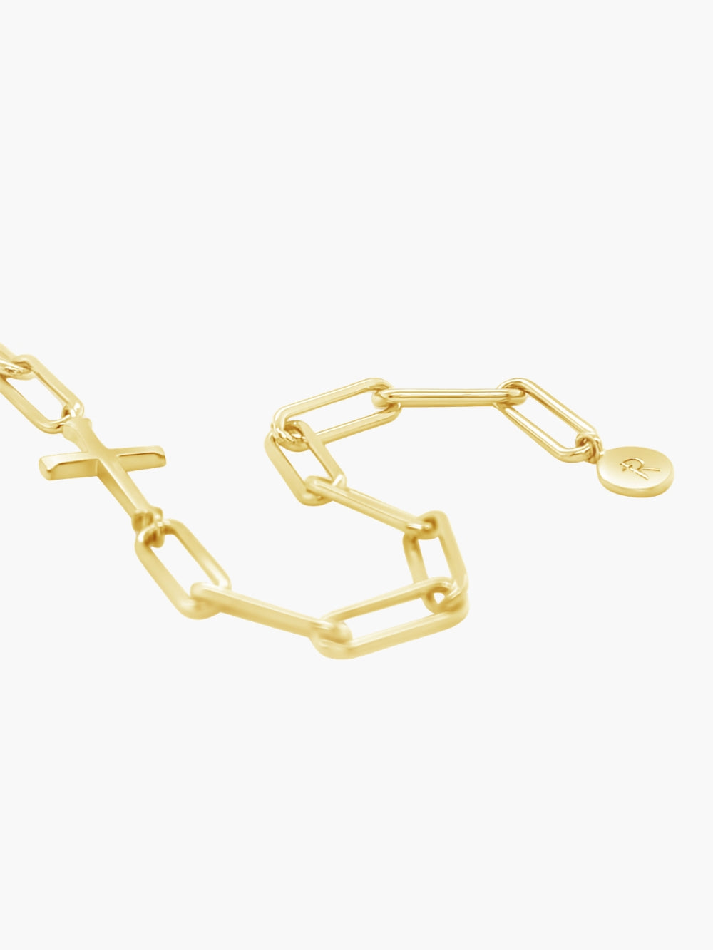Rizen Jewelry Chain Breaker cross bracelet in 18k gold plated.  Elegant Cross Pendant breaks up the contemporary paper clip link chain with circular Rizen tag on last link of chain.