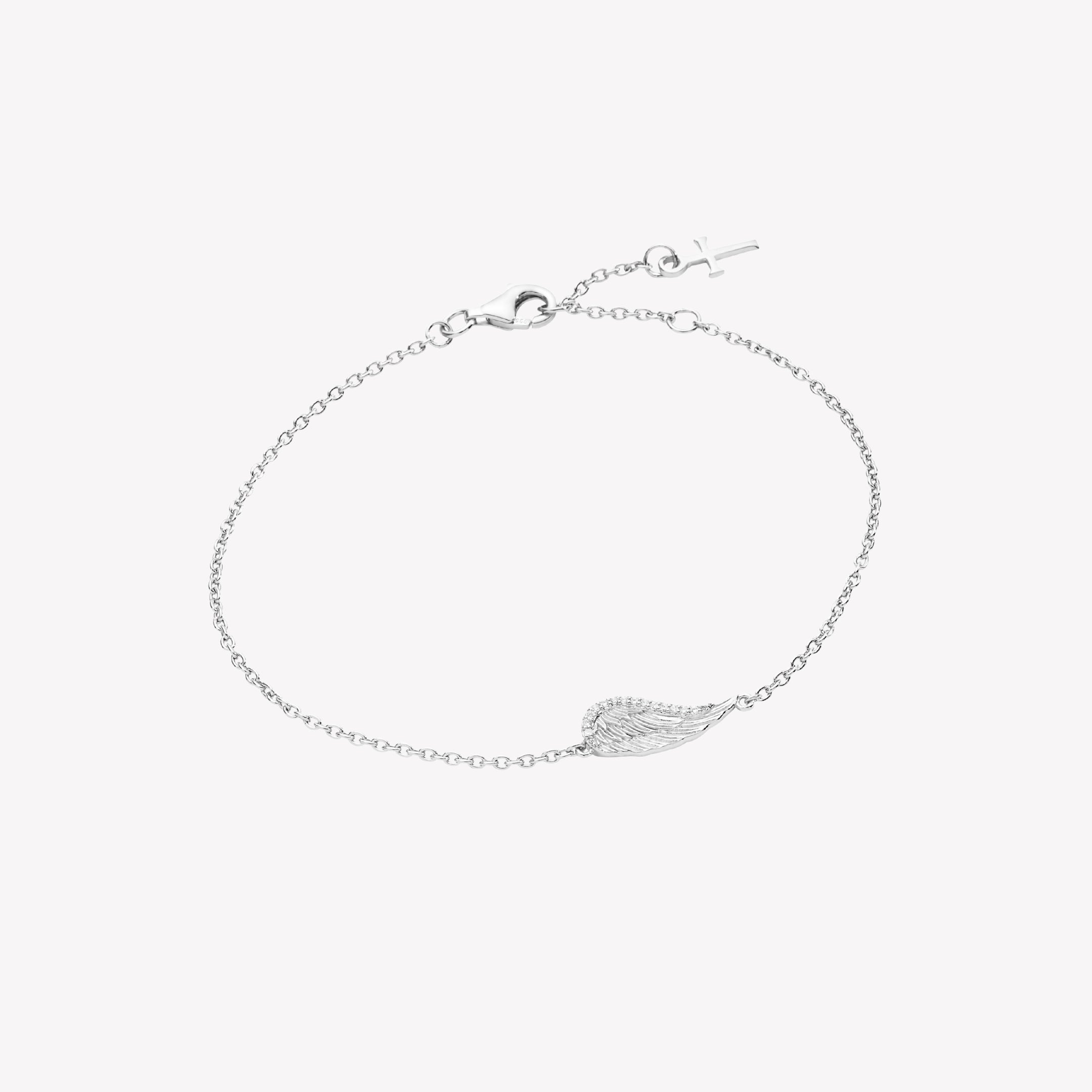 Sterling silver bracelet showcases a captivating single wing motif, elegantly outlined with sparkling cubic zirconia accents set on a cable chain with a cross tag pendant from the Insignia Collection by Rizen Jewelry.