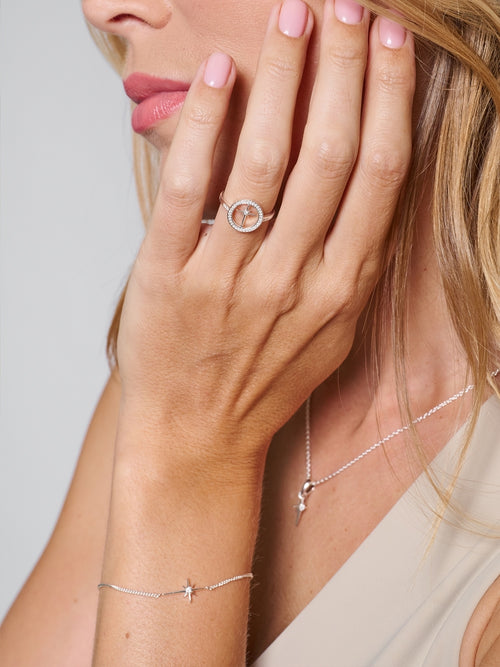 Female Christian Jewelry Model wearing the sterling silver Adoring Star Bracelet, styled with the matching ring and necklace designed by Rizen Jewelry. 