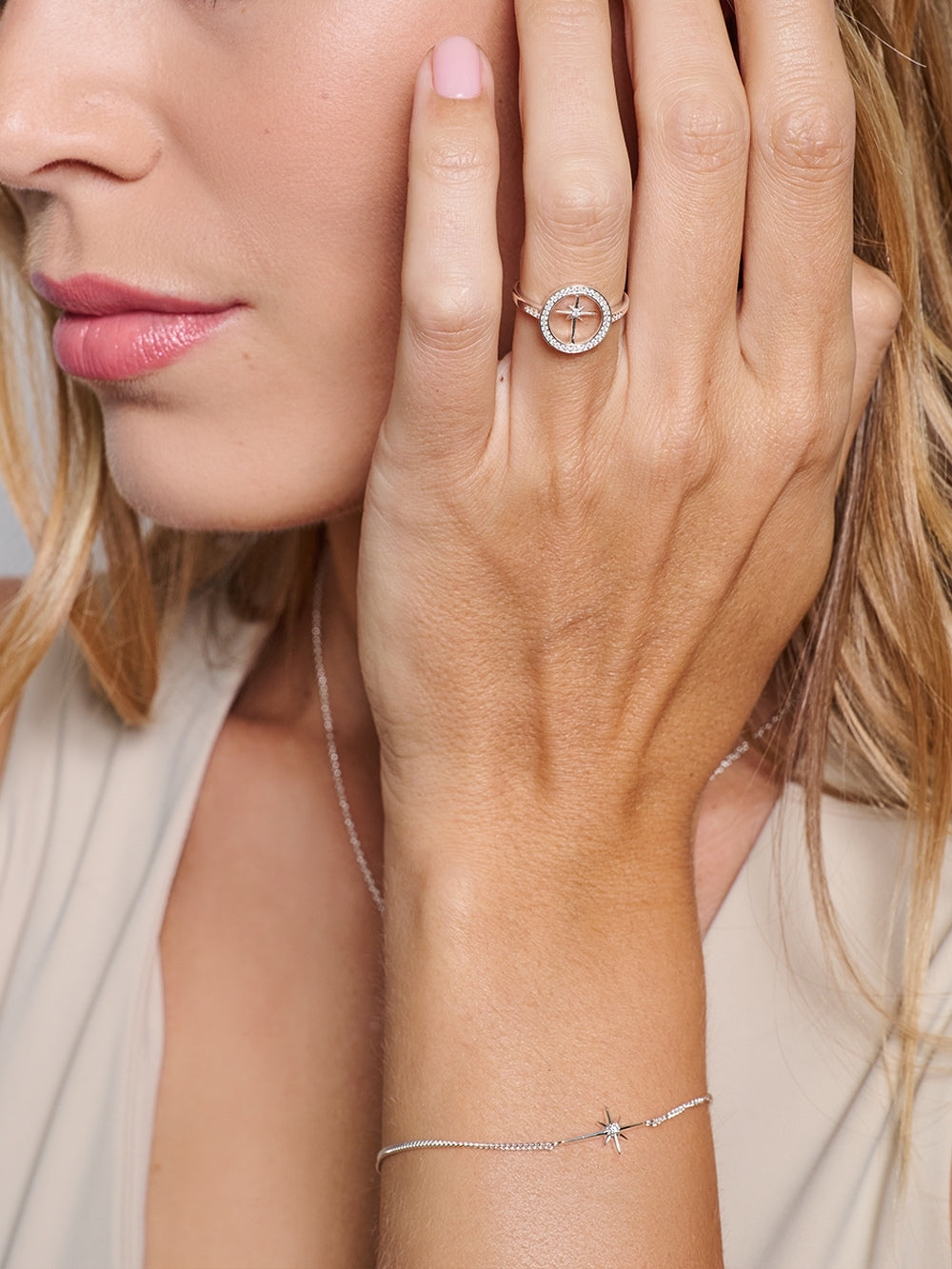 Female Christian Jewelry Model wearing the sterling silver Adoring Star Bracelet, styled with the matching ring and necklace designed by Rizen Jewelry. 