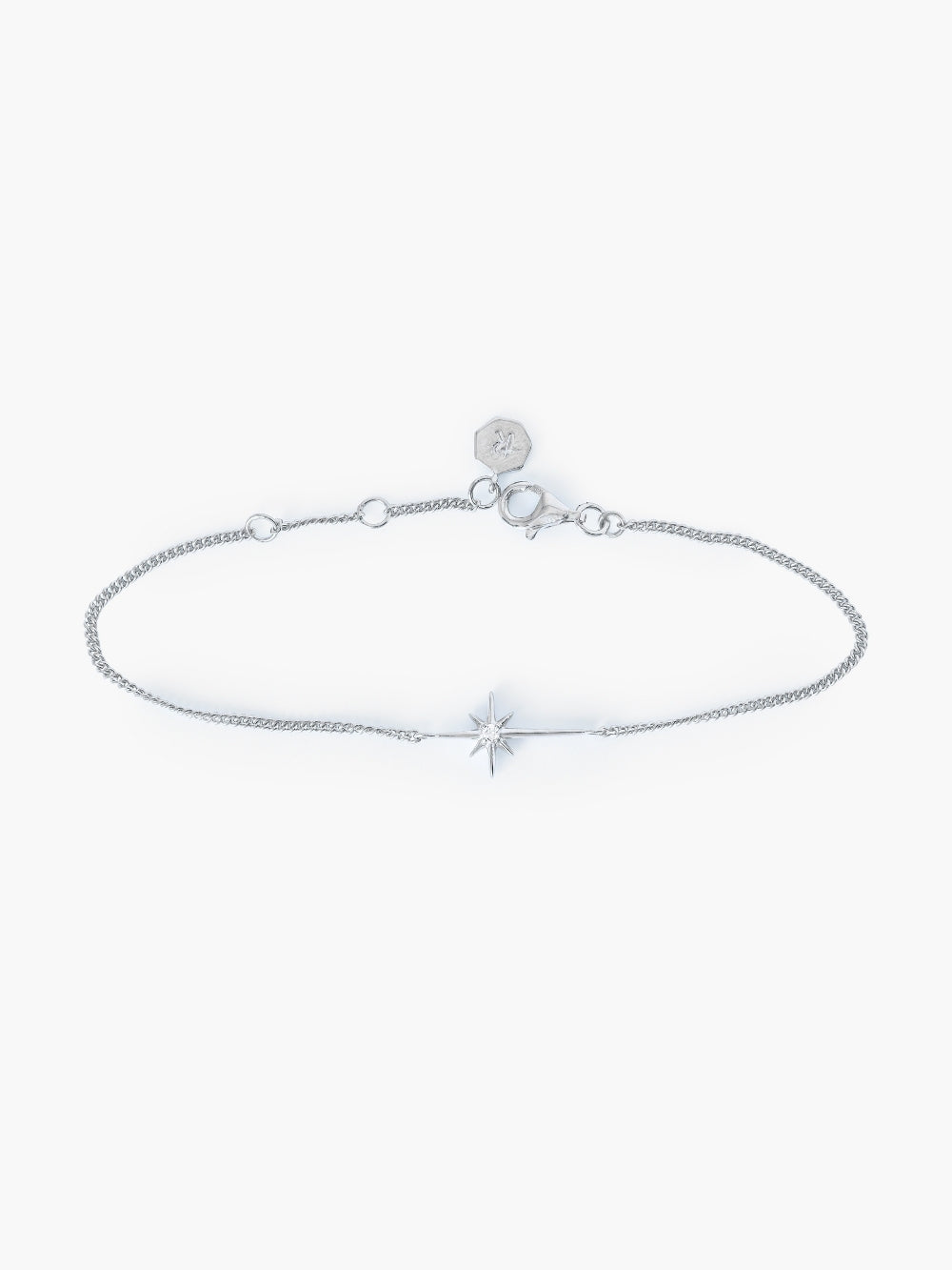 Adoring Star Bracelet with star-cross charm and cubic zirconia on silver curb chain, designed by Rizen Jewelry.