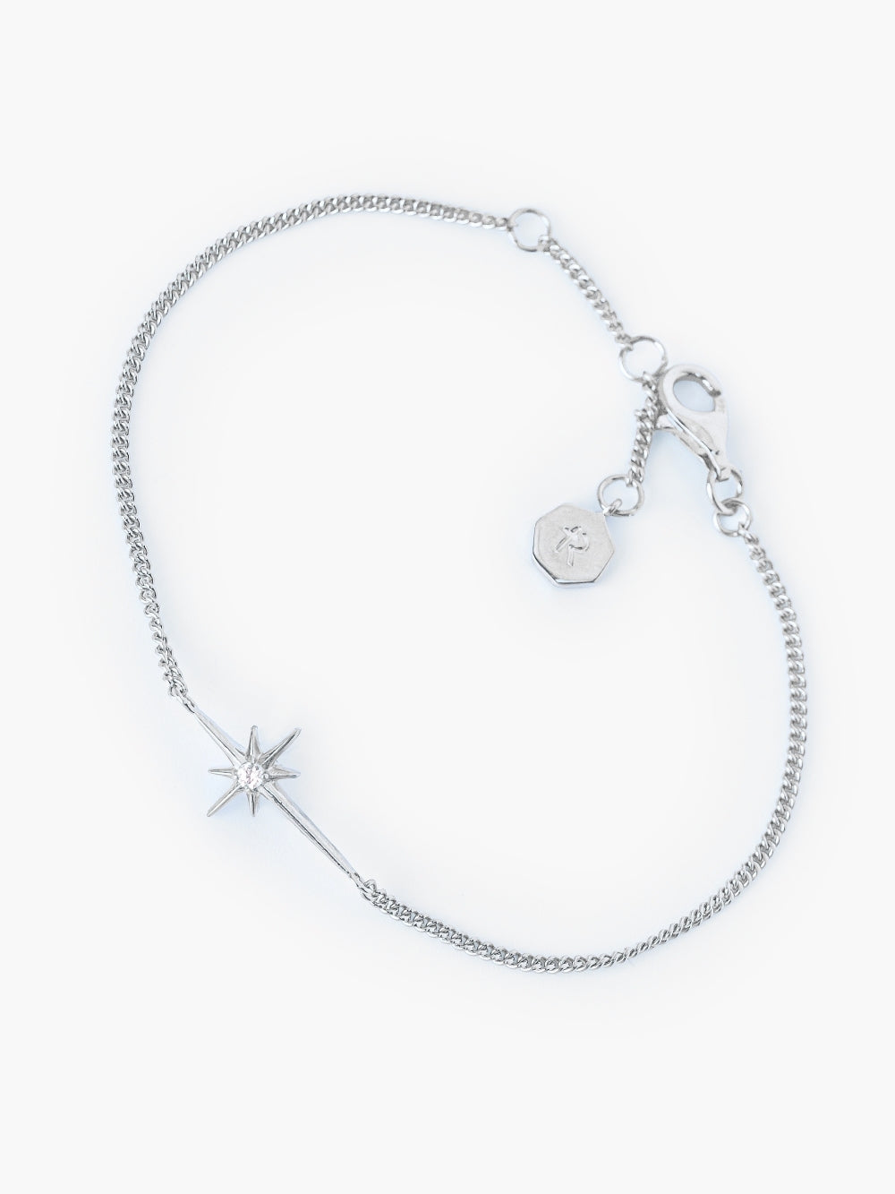 Adoring Star Bracelet with star-cross charm and cubic zirconia on silver curb chain, designed by Rizen Jewelry.