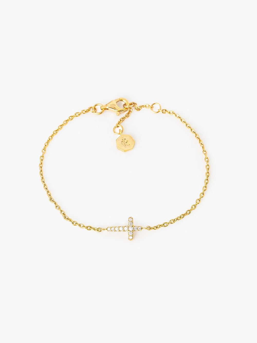 Dainty Luminous Cross Pavé Bracelet in 18k gold-plated sterling silver with a cubic zirconia cross pendant set on a cable chain designed by Rizen Jewelry.