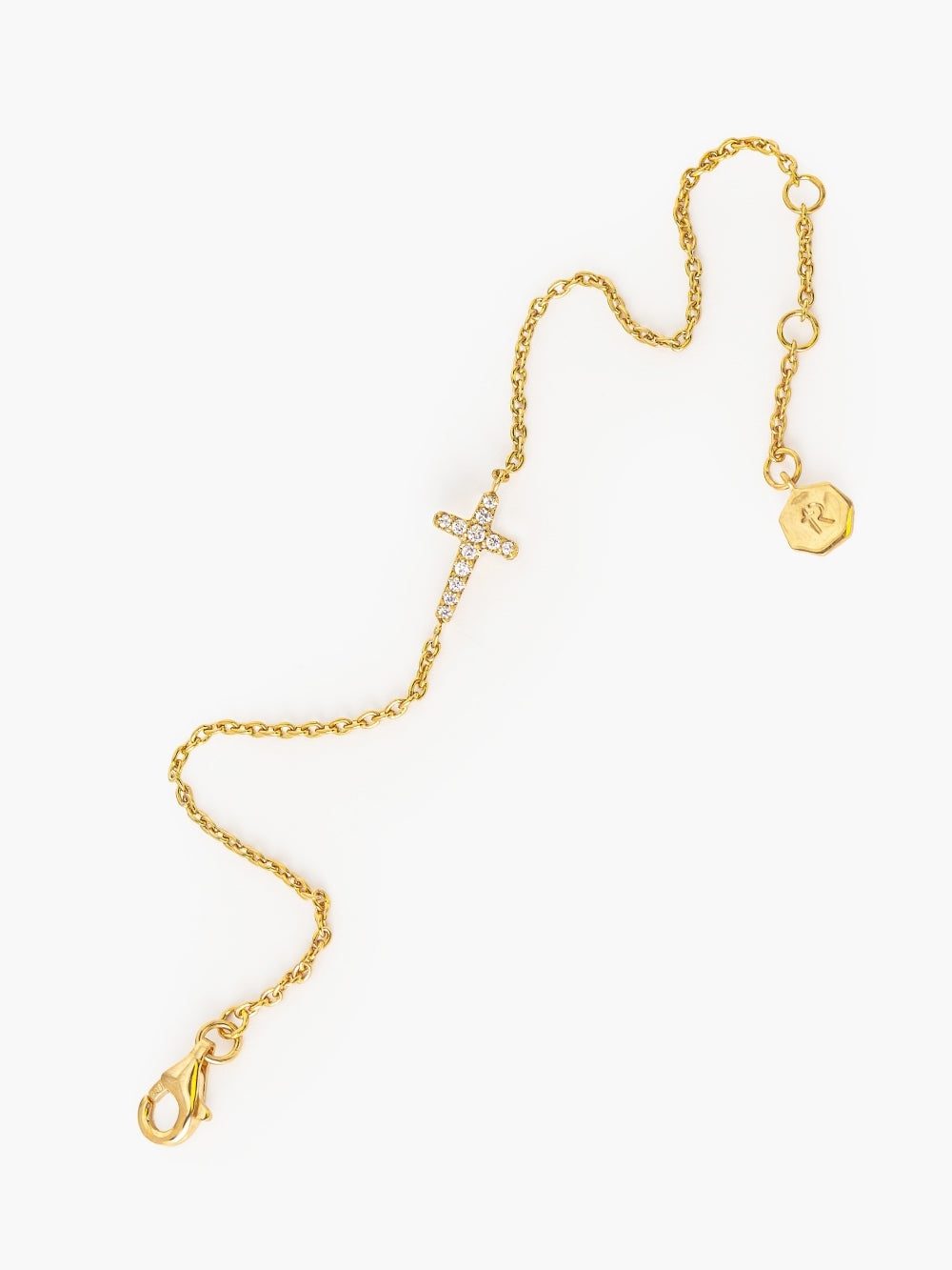 Dainty Luminous Cross Pavé Bracelet showing three length settings on a gold adjustable cable chain designed by Rizen Jewelry. 
