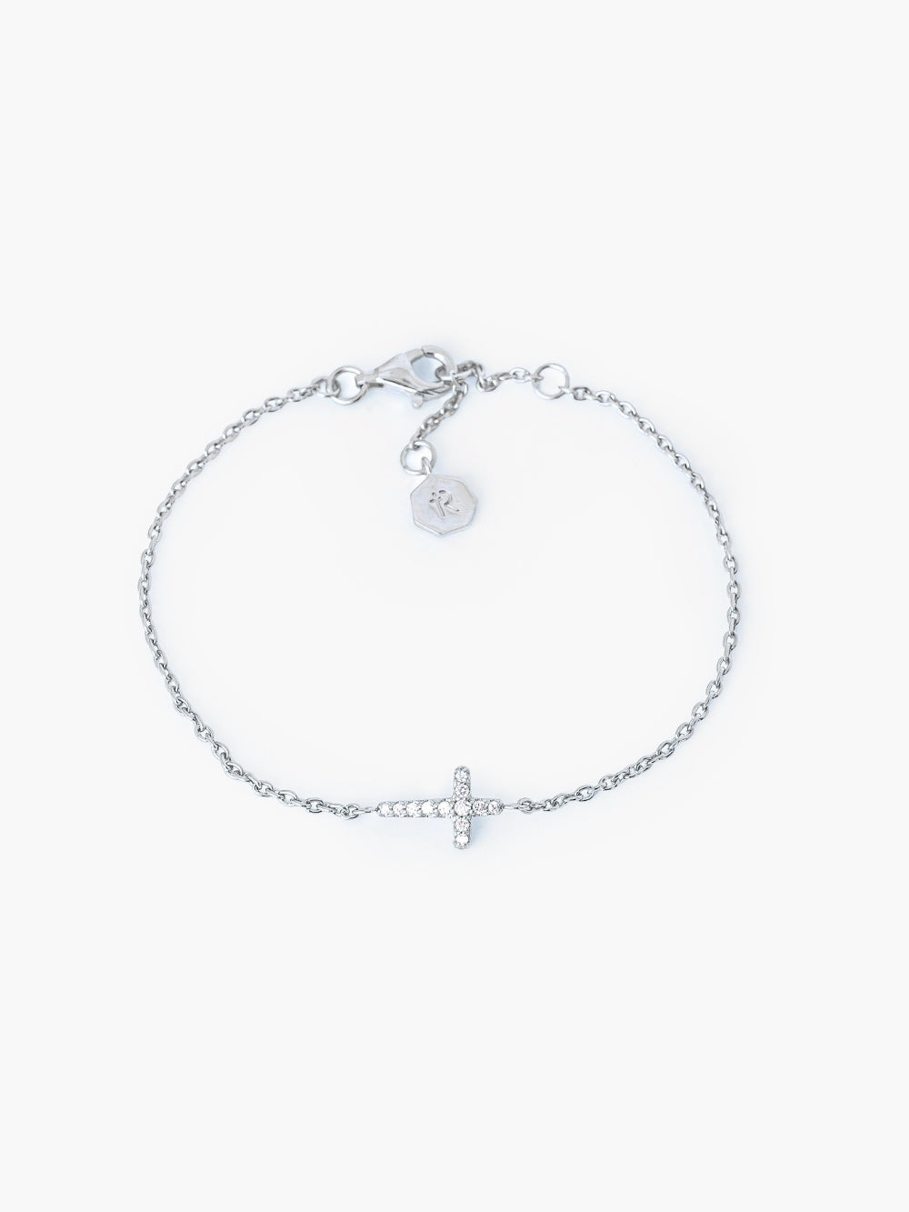 Dainty Luminous Cross Pavé Bracelet in sterling silver with cubic zirconia cross pendant set on a cable chain, adjustable to three length settings by Rizen Jewelry. 