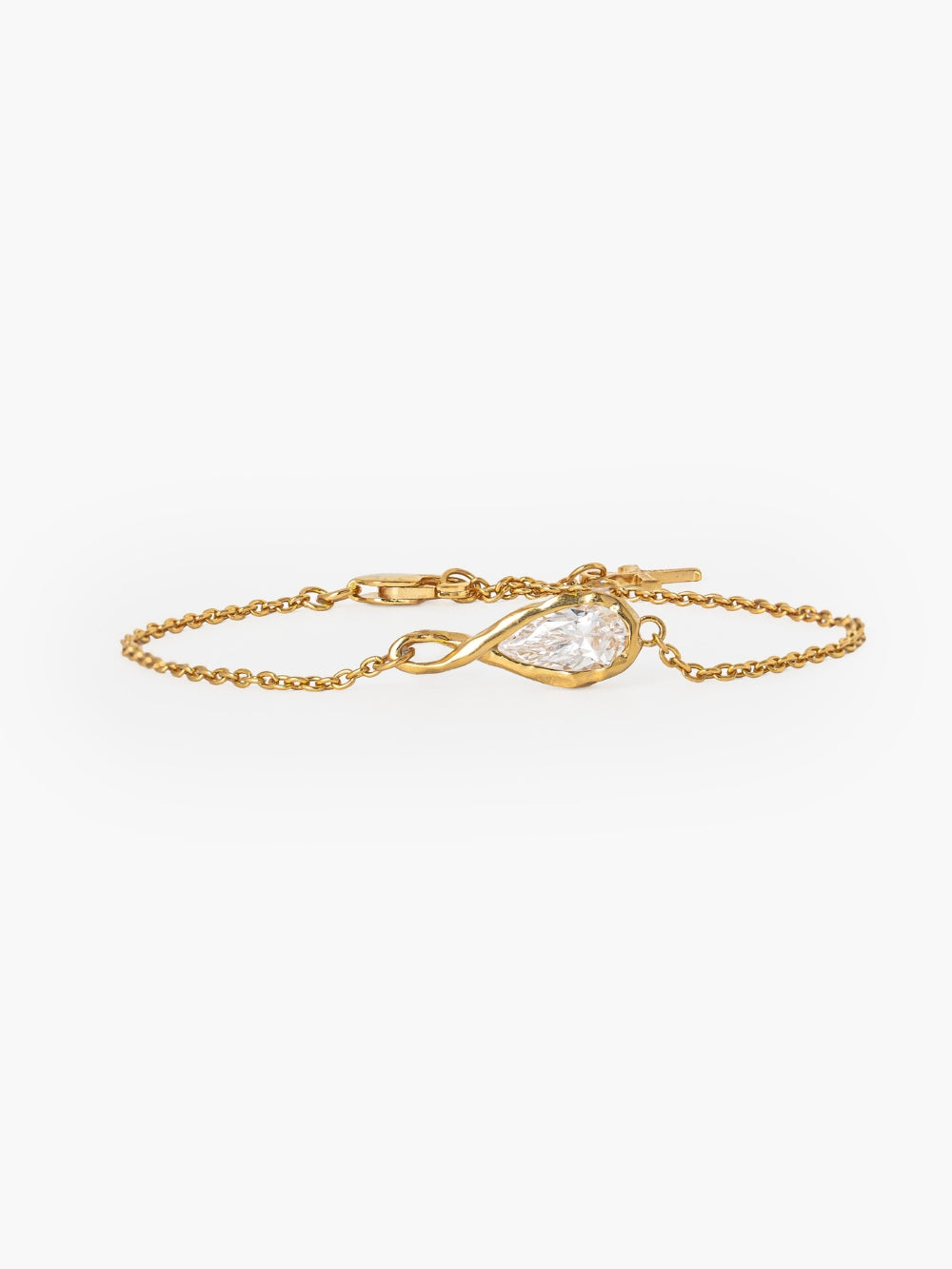 Rizen Jewelry's Solace Teardrop Bracelet is a delicate gold chain bracelet featuring a teardrop-shaped simulated diamond in a gold bezel setting, that forms an infinity symbol. Featured on a plain white background.