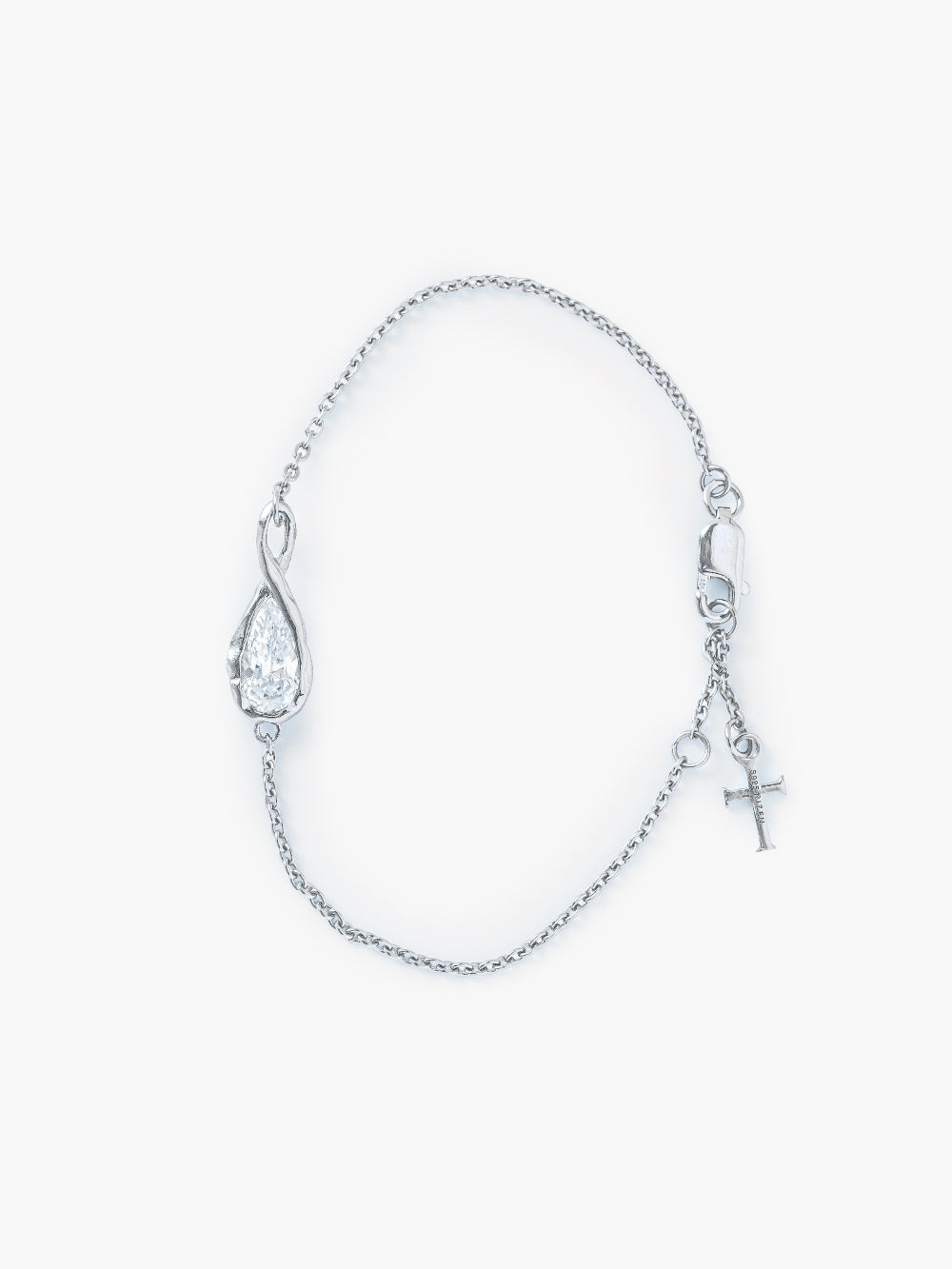 Rizen Jewelry Solace Teardrop Bracelet is a delicate silver cable chain bracelet with a teardrop infinity pendant with a teardrop shaped simulated diamond also has a lobster clasp and signature Rizen Cross Pendant Tag. 