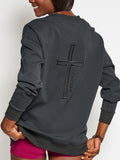 Christian female sweatshirt model wearing Chosen cross sweatshirt styled with shorts.