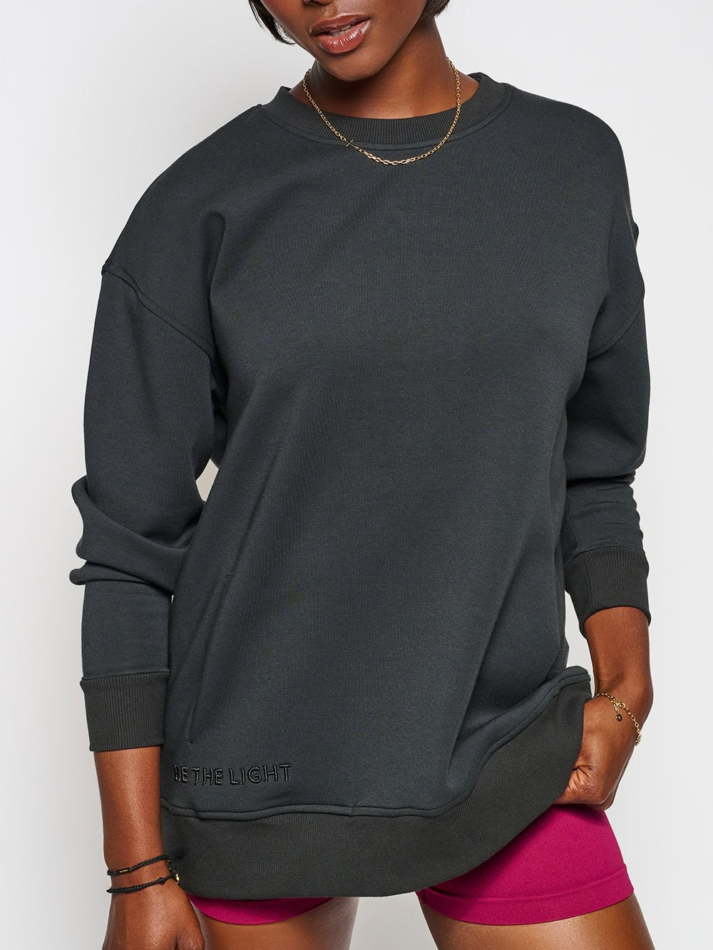 Christian female sweatshirt model wearing Chosen cross sweatshirt styled with shorts