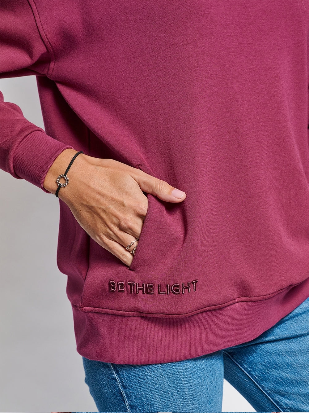 Loved crew neck sweatshirt with BE THE LIGHT embroidery and discreet front pockets