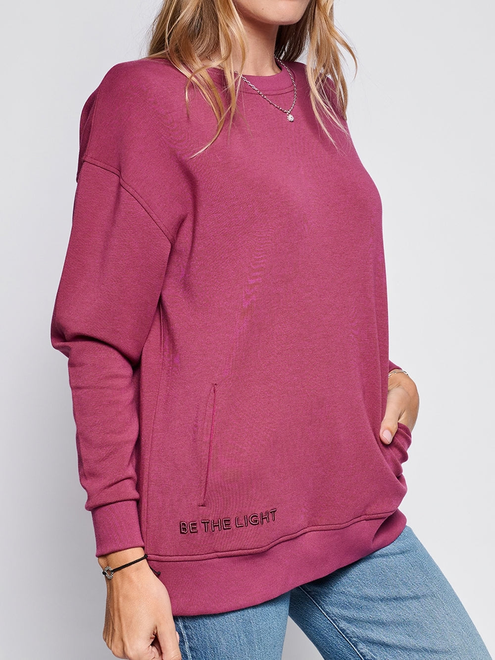 A Christian Female Model wearing Loved John 3:16 sweatshirt styled with jeans