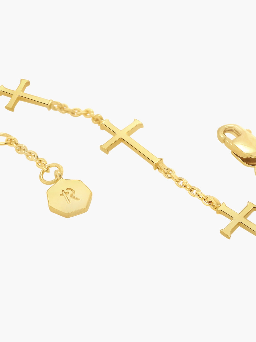 Up close detail of the Calvary cross bracelet in 18k gold plated from the Calvary collection.  A timeless baptism gift by Rizen Jewelry.