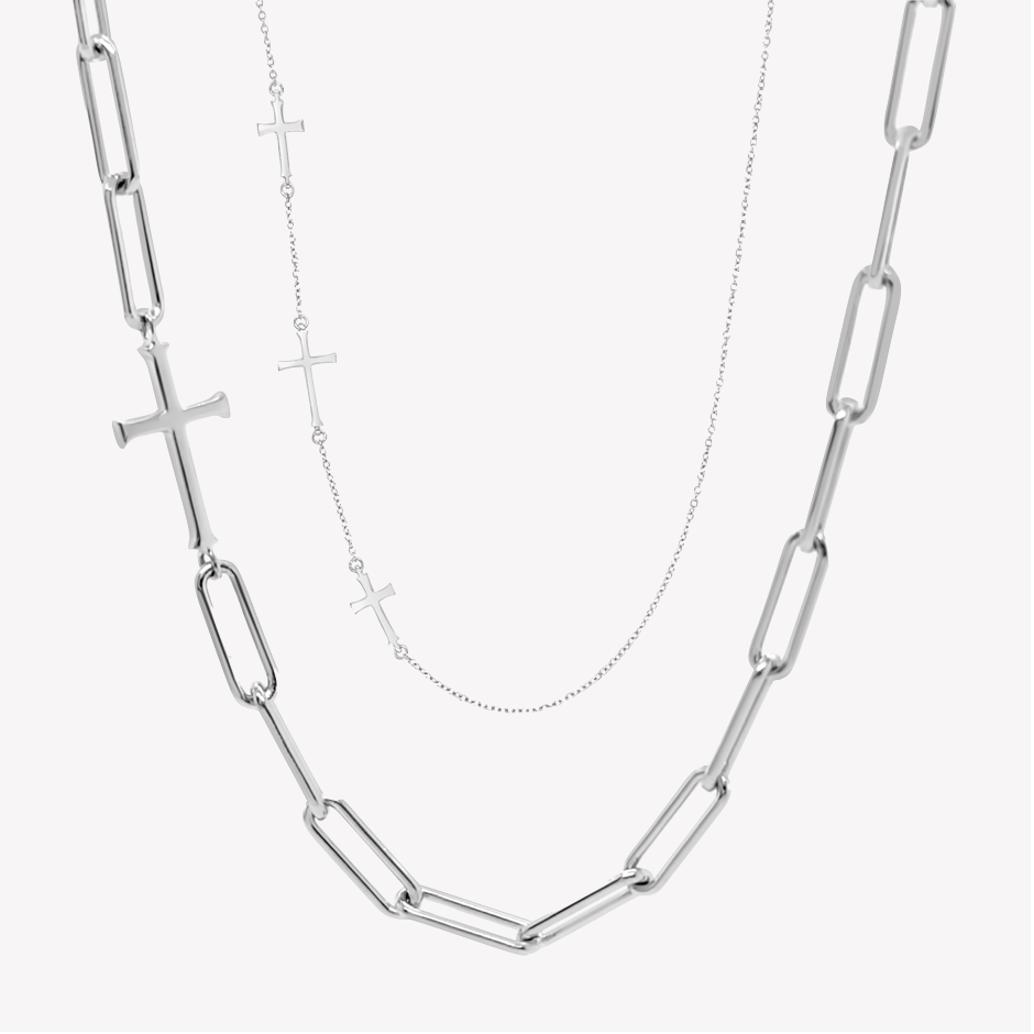 Close up of the chain breaker and calvary cross station necklaces in sterling silver from the calvary collection by Rizen Jewelry