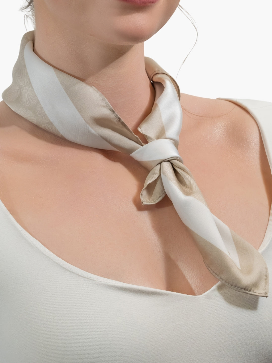 Christian woman model wearing a Rizen scarf tied around her neck. 