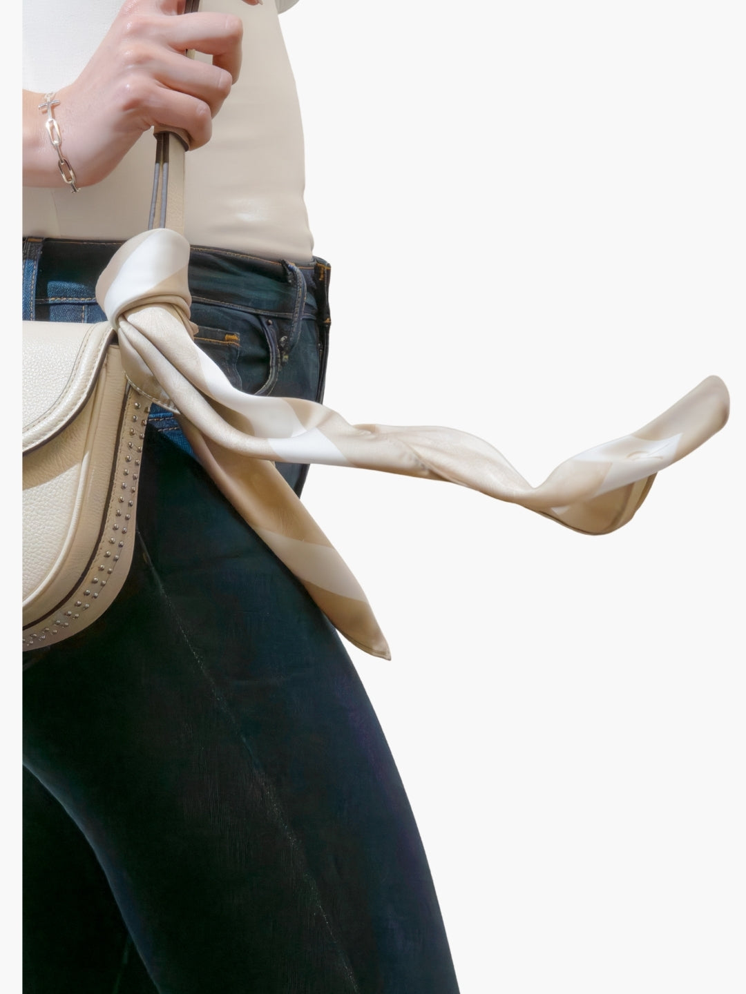 Christian women model wearing beige purse with Rizen scarf tied on the end 