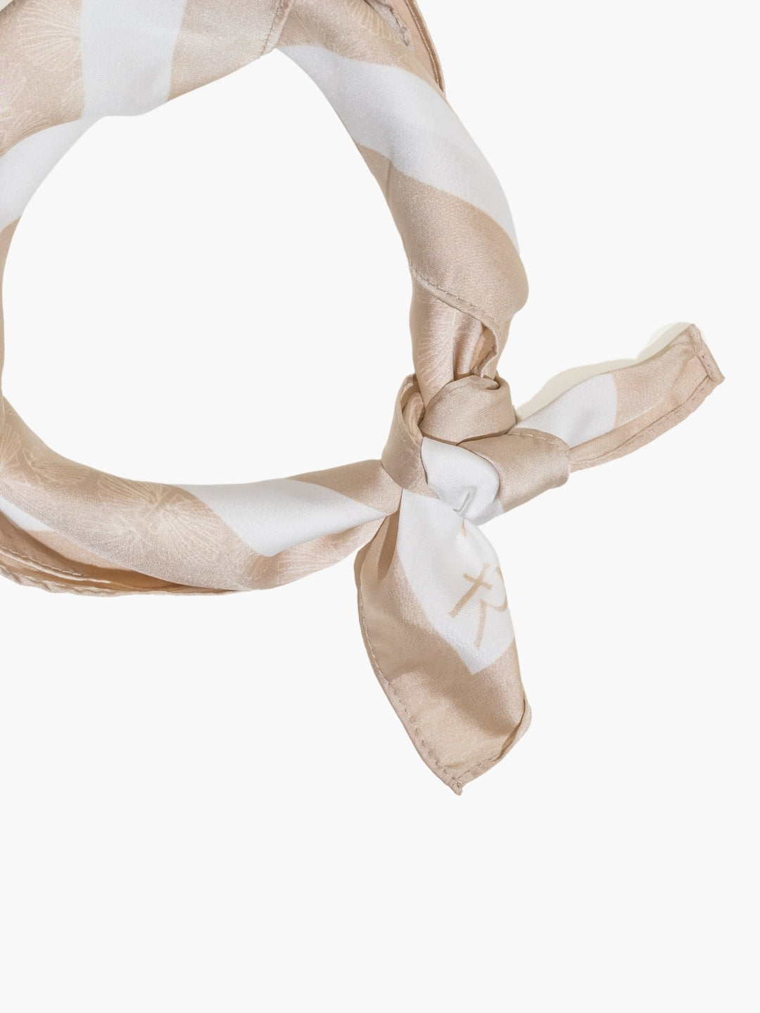 Beige and white patterned Rizen scarf tied in a knot on a white background.