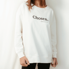 Christian woman wearing the sand off white "Chosen. Ephesians 1:4" Peruvian cotton crew sweatshirt from the Be The Light Collection by Rizen Jewelry.