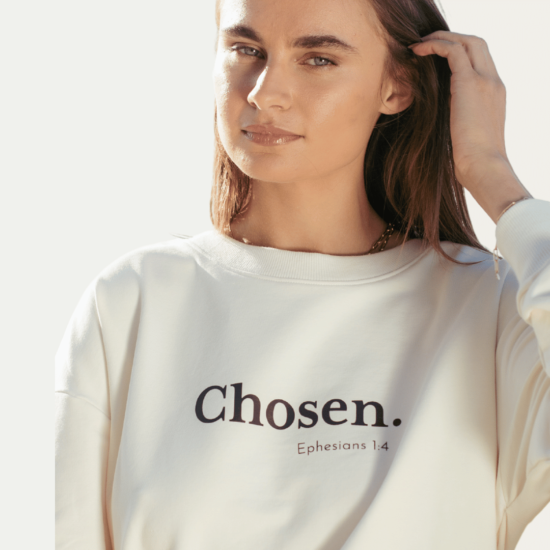 Close up of the sand off white "Chosen. Ephesians 1:4" Peruvian cotton crew sweatshirt from the Be The Light Collection by Rizen Jewelry.