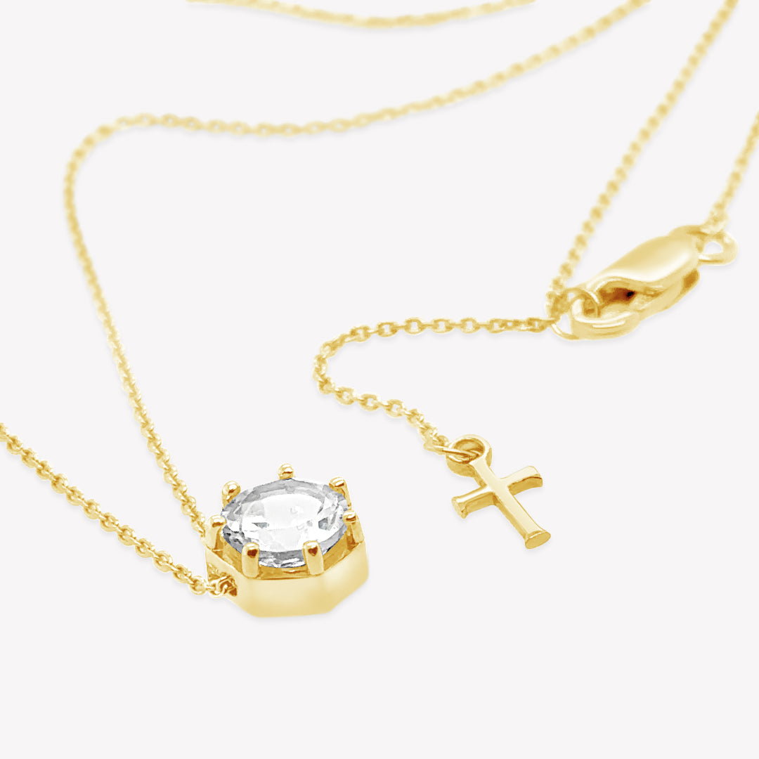 Rizen Jewelry Ebenezer solitaire white topaz necklace in gold vermeil set in 7 prongs in a heptagon setting from the Chispa Collection.