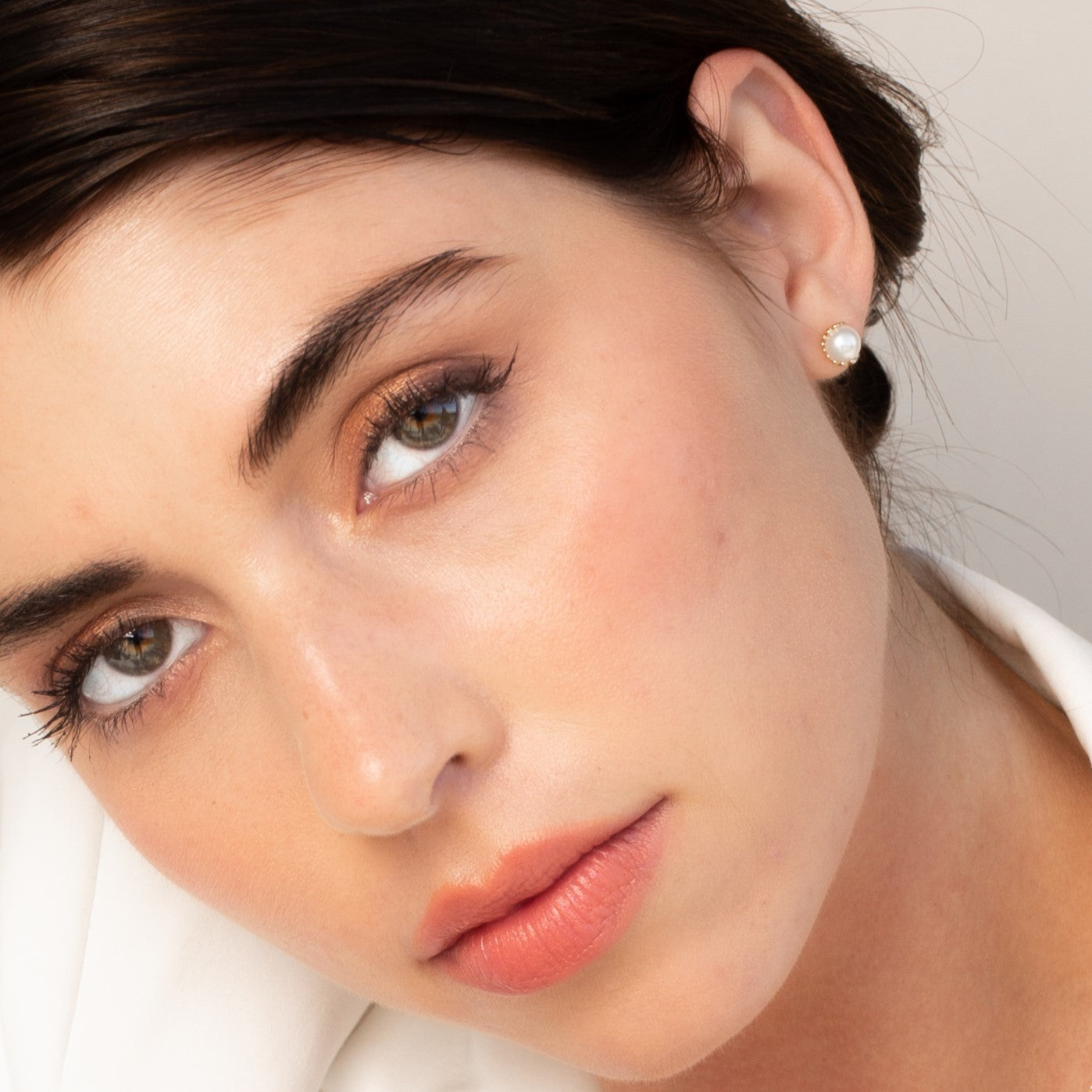 Christian model wearing Rizen Jewelry shell encased pearl earring in sterling silver from the Becoming Collection.