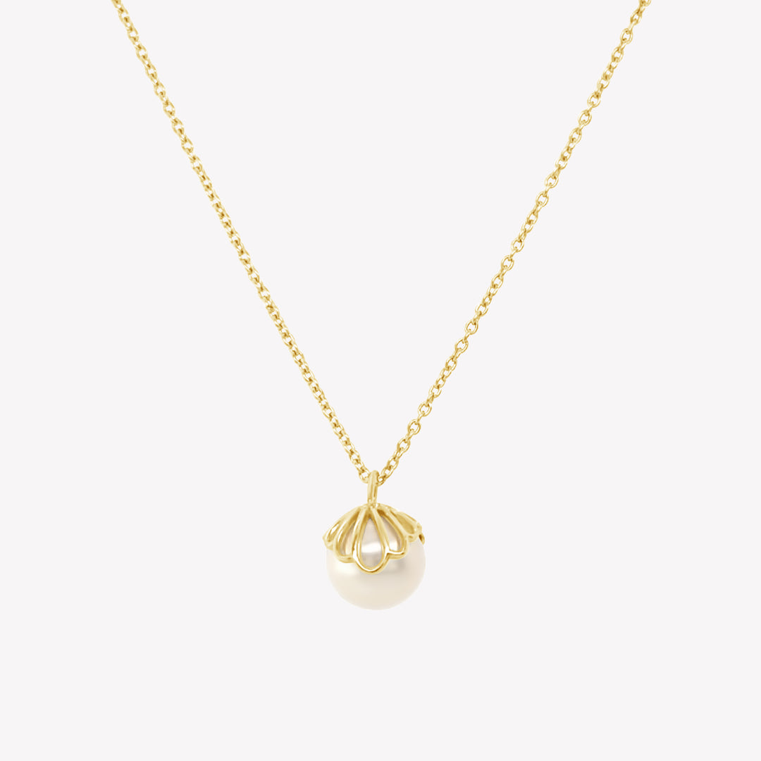 Rizen Jewelry shell encased pearl necklace in gold vermeil from the Becoming Collection.