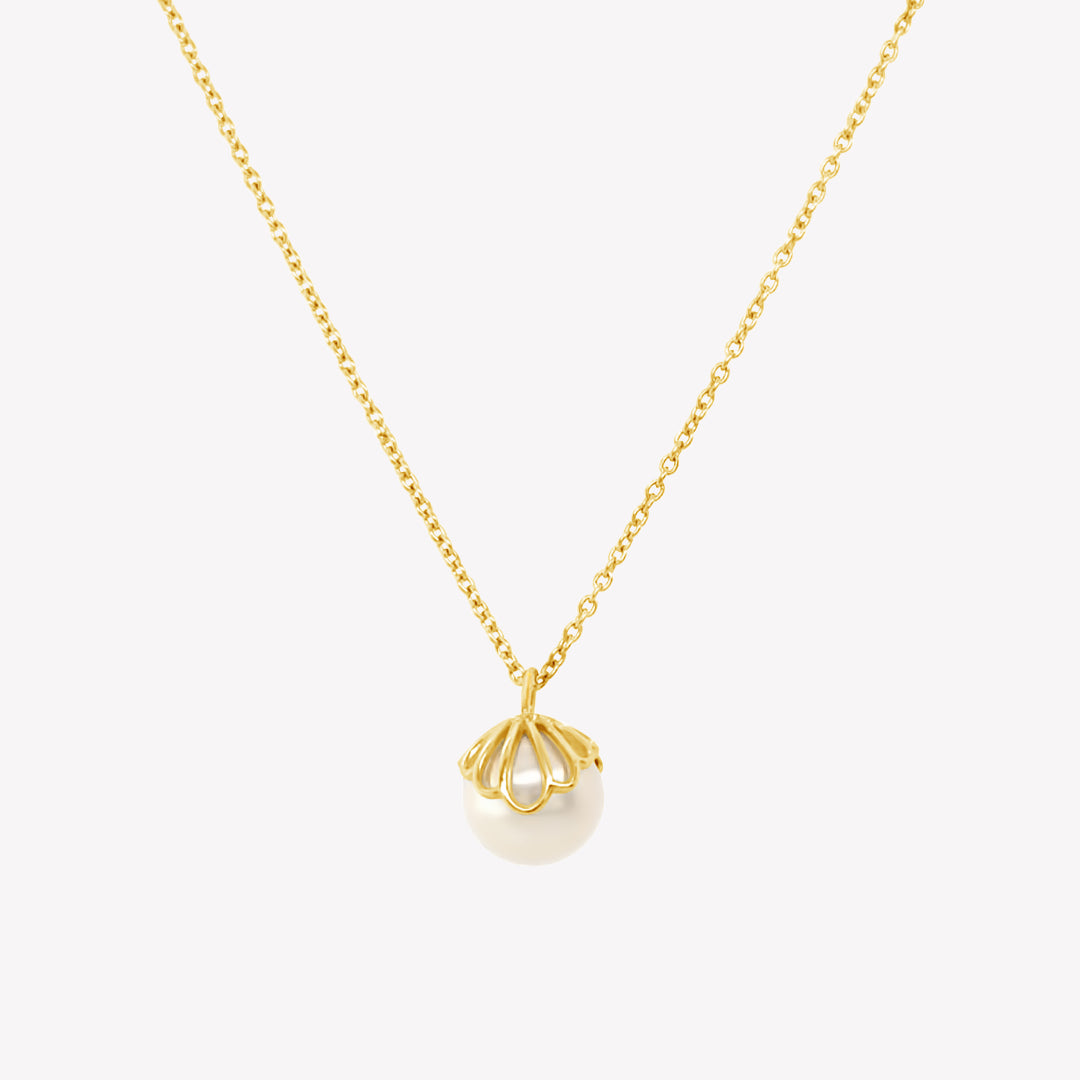 Rizen Jewelry shell encased pearl necklace in gold vermeil from the Becoming Collection.