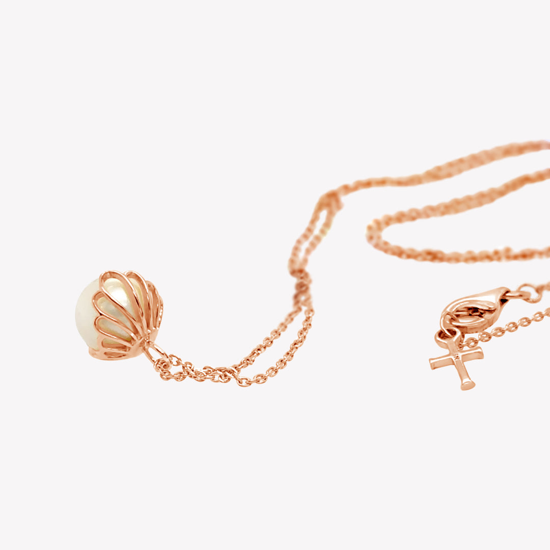Rizen Jewelry shell encased pearl necklace in rose gold vermeil from the Becoming Collection.