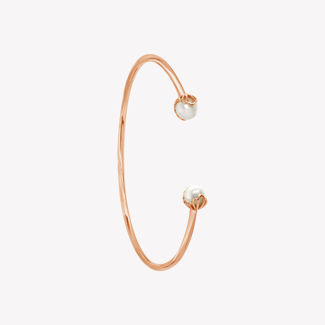 Rizen Jewelry shell encased pearl bangle in rose gold vermeil from the Becoming Collection.
