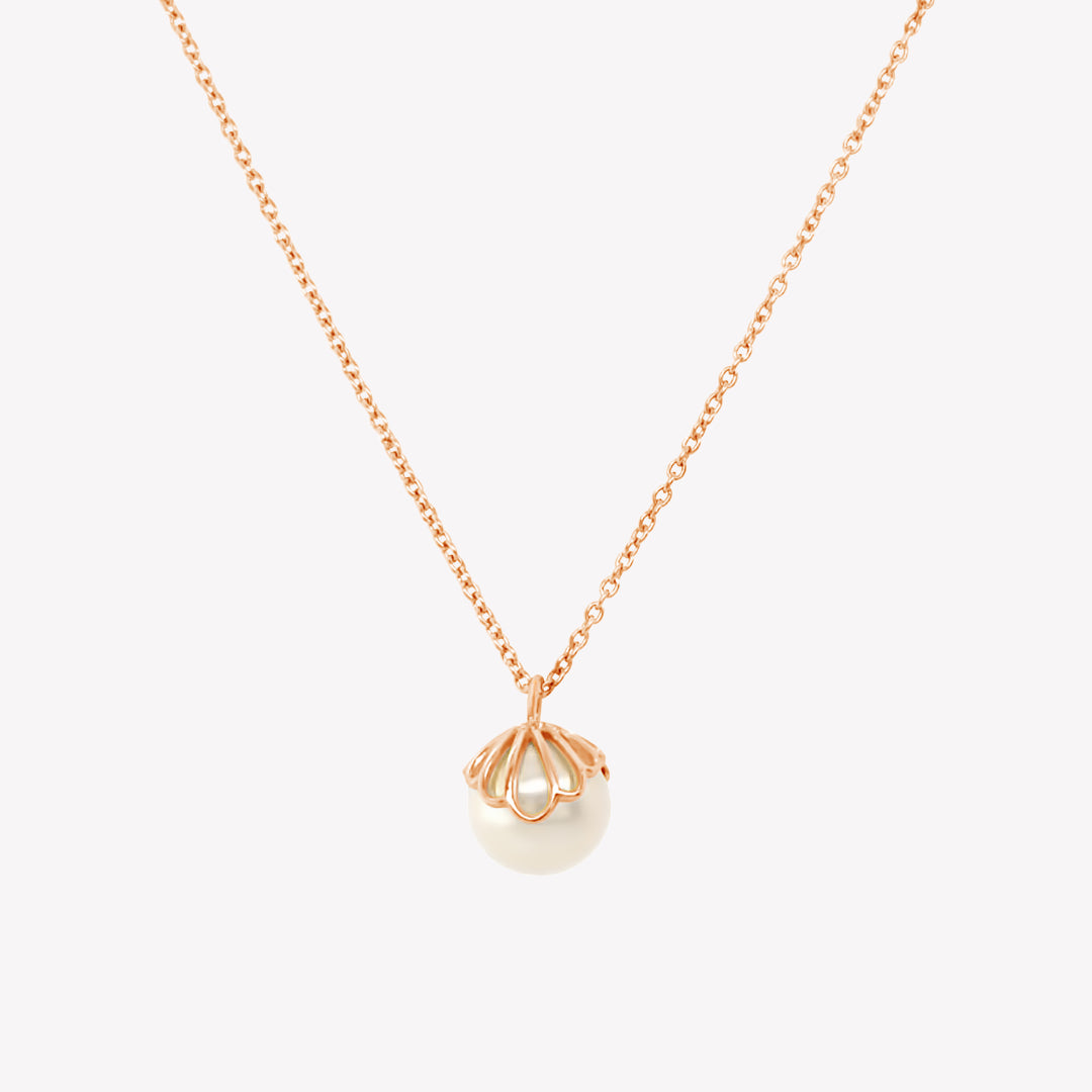 Rizen Jewelry shell encased pearl necklace in rose gold vermeil from the Becoming Collection.