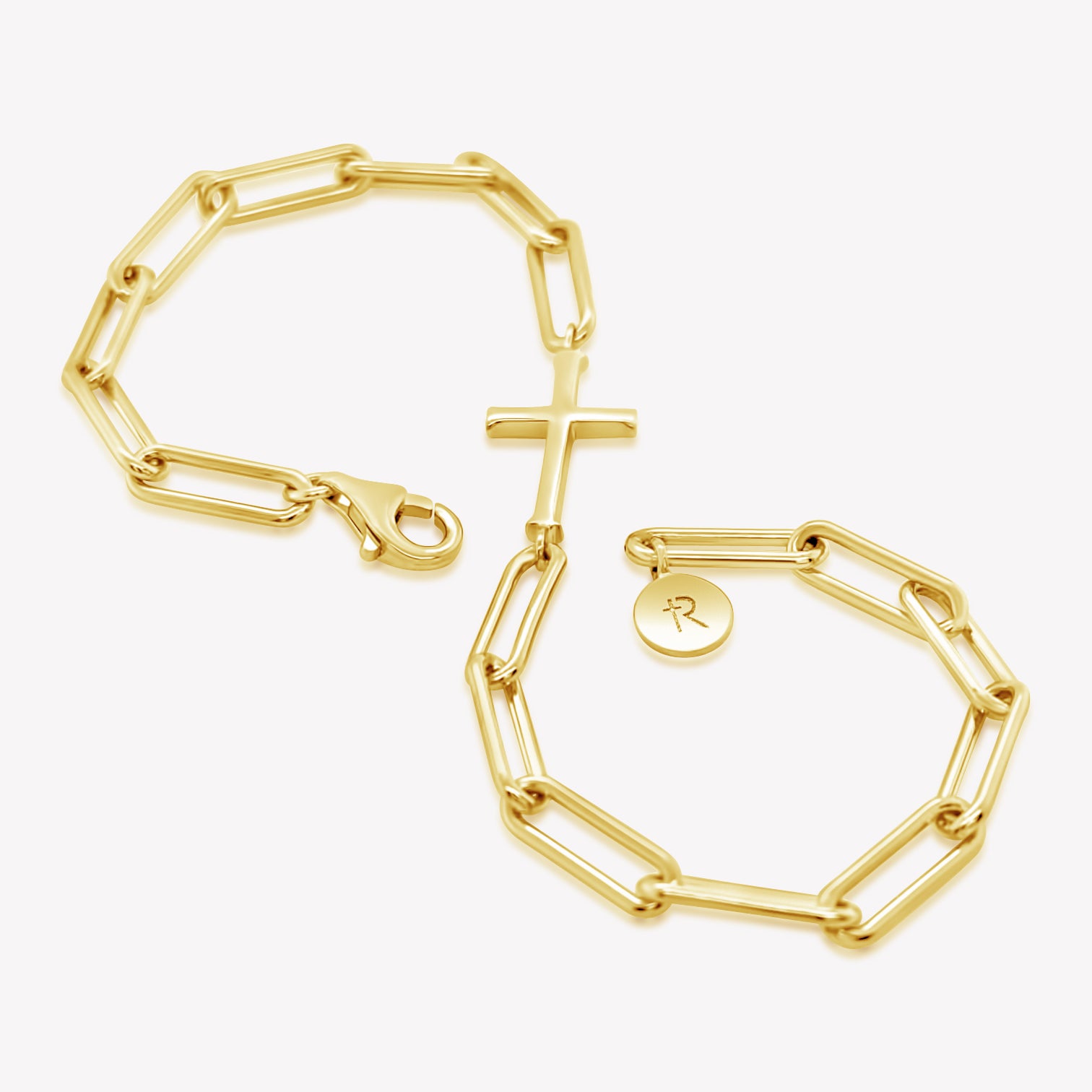 Rizen Jewelry Chain Breaker bracelet in 18kt yellow gold.  Elegant Cross Pendant breaks up the contemporary paper clip link chain with classic lobster clasp  closure, and circular Rizen tag on last link of chain wrapped in the shape of an infinity symbol.