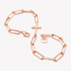 Rizen Jewelry Chain Breaker bracelet in 18kt rose gold.  Elegant Cross Pendant breaks up the contemporary paper clip link chain with classic lobster clasp  closure, and circular Rizen tag on last link of chain wrapped in the shape of an infinity symbol.
