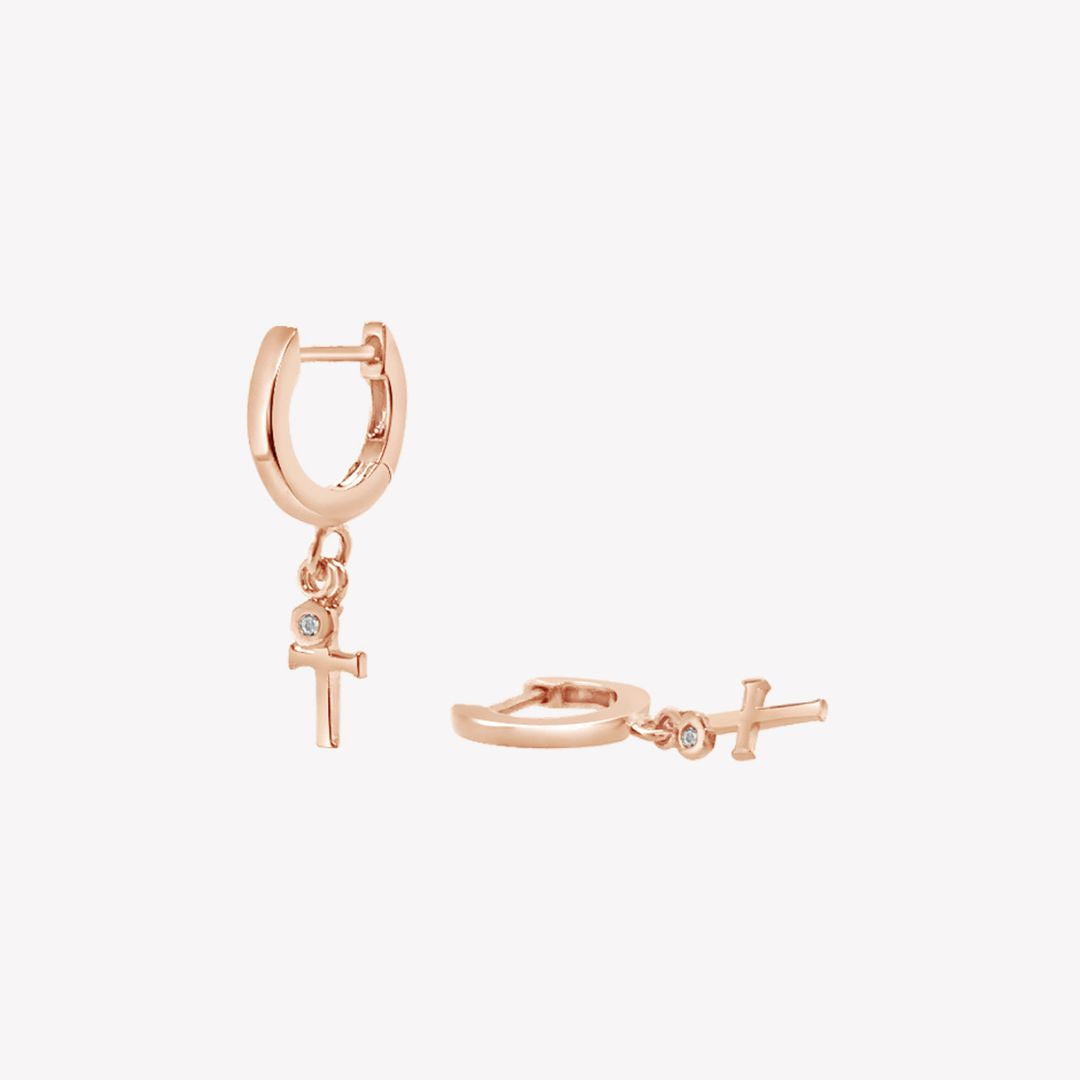 Rizen Jewelry rose gold vermeil Cross Huggie Hoop Earrings with white topaz stone dangle from the Calvary Collection.