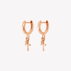 Rizen Jewelry rose gold vermeil Cross Huggie Hoop Earrings with white topaz stone dangle from the Calvary Collection.
