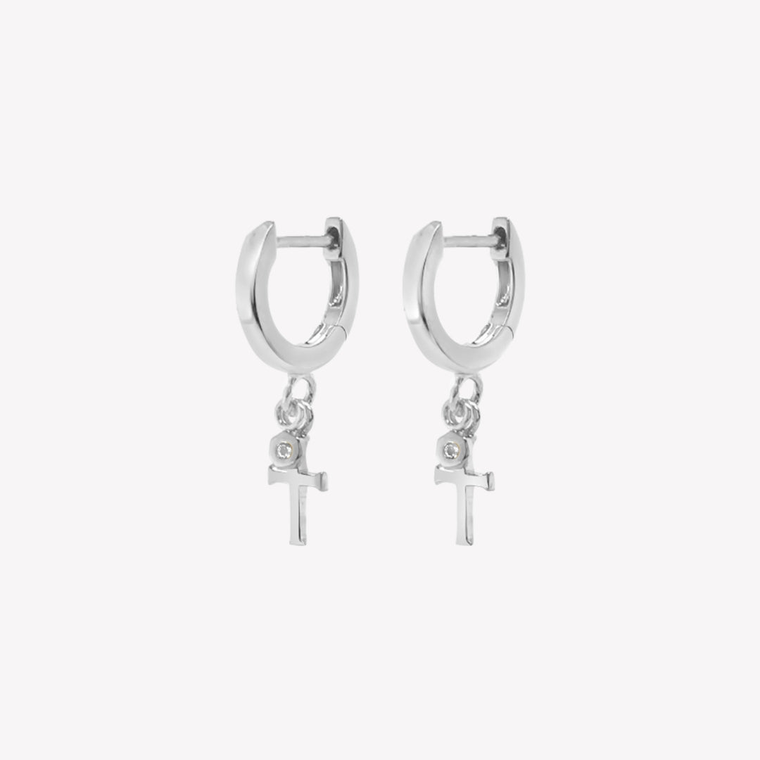 Rizen Jewelry sterling silver Cross Huggie Hoop Earrings with white topaz stone dangle from the Calvary Collection.