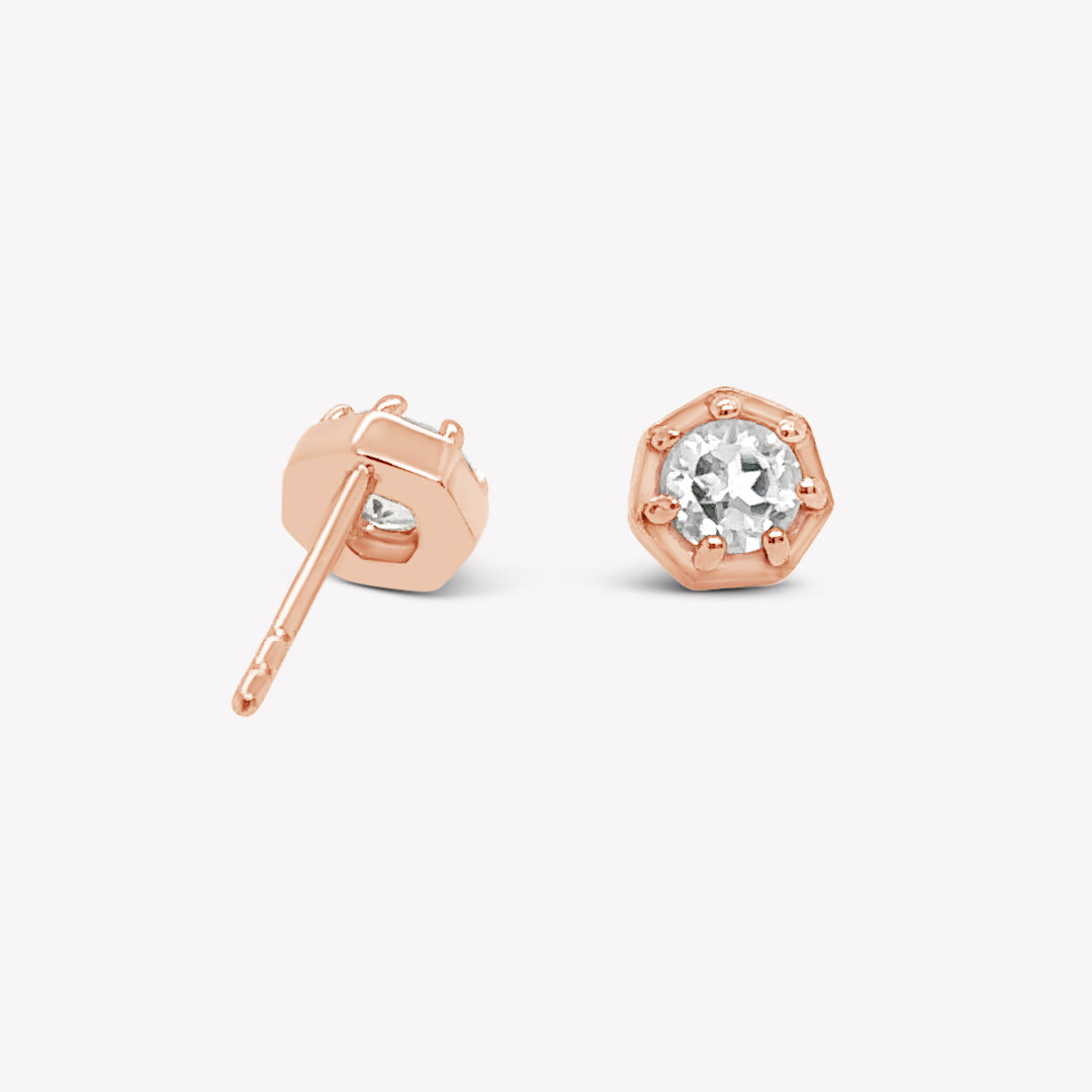 Rizen Jewelry Ebenezer solitaire white topaz earring in rose gold vermeil set in 7 prongs in a heptagon setting from the Chispa Collection. 
