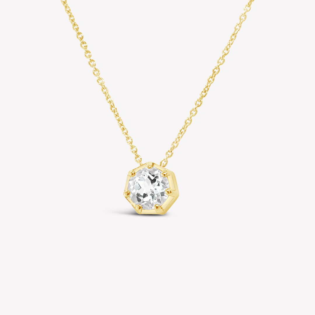 Rizen Jewelry Ebenezer solitaire white topaz necklace in gold vermeil set in 7 prongs in a heptagon setting from the Chispa Collection.