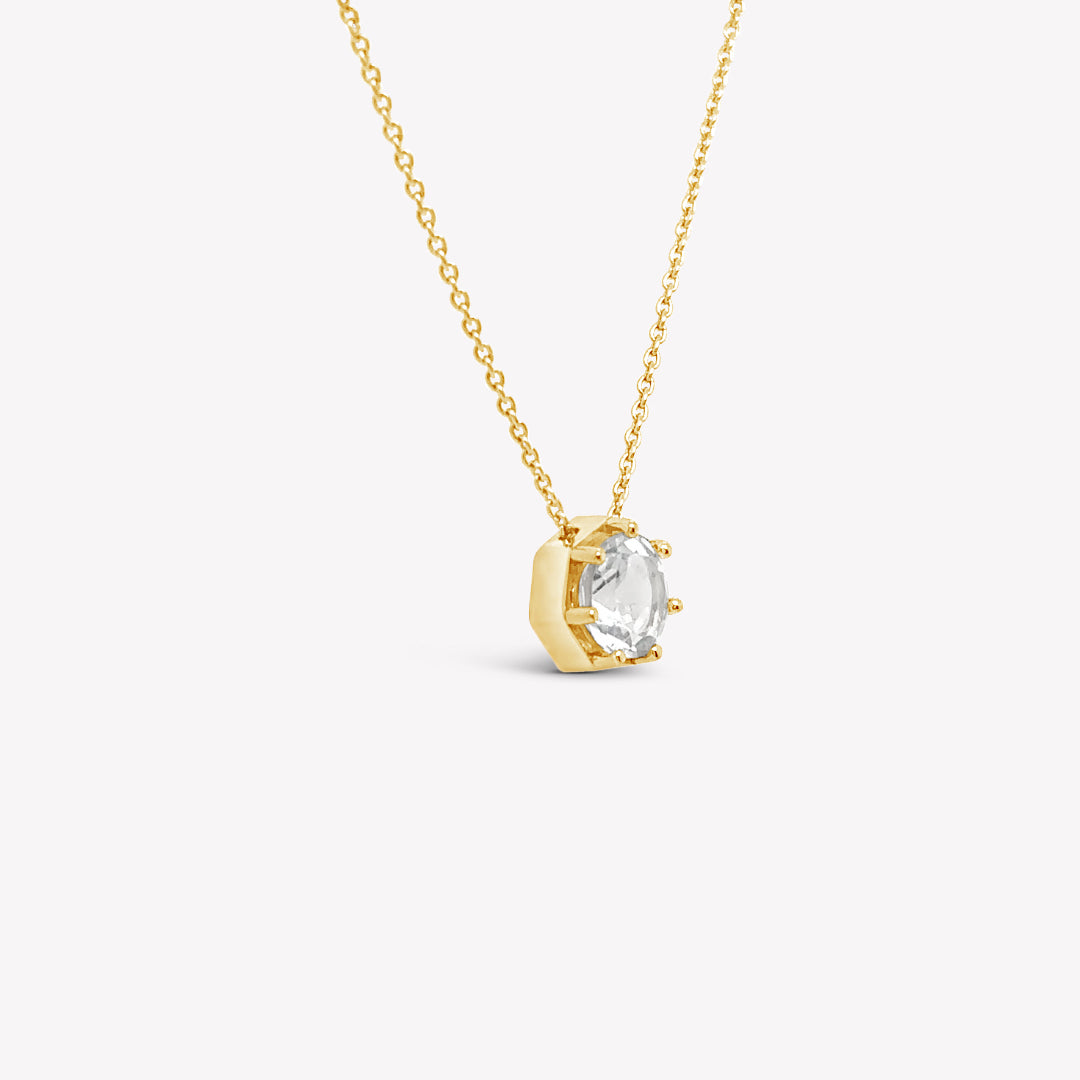 Rizen Jewelry Ebenezer solitaire white topaz necklace in gold vermeil set in 7 prongs in a heptagon setting from the Chispa Collection.