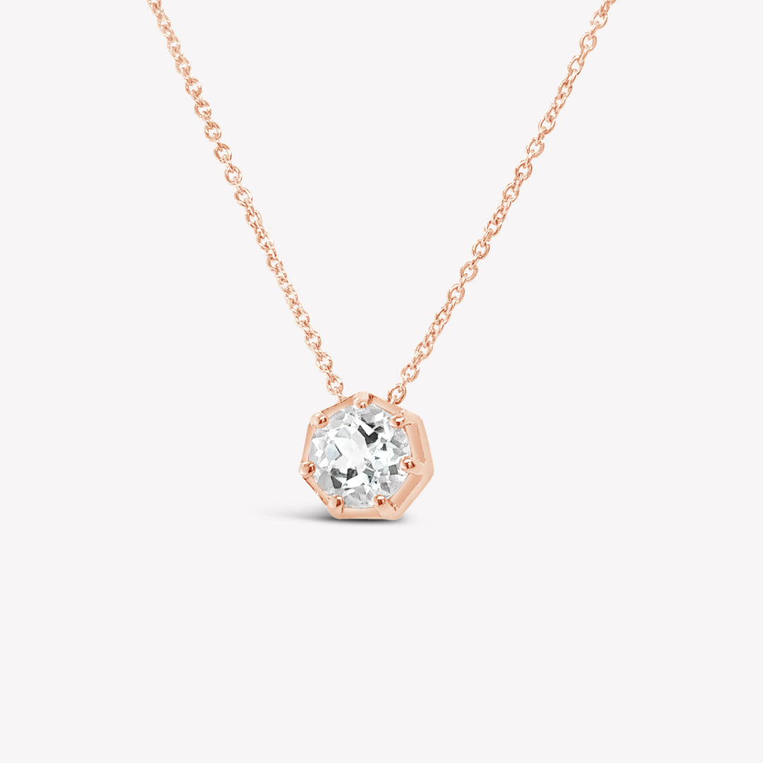 Rizen Jewelry Ebenezer solitaire white topaz necklace in rose gold vermeil set in 7 prongs in a heptagon setting from the Chispa Collection.