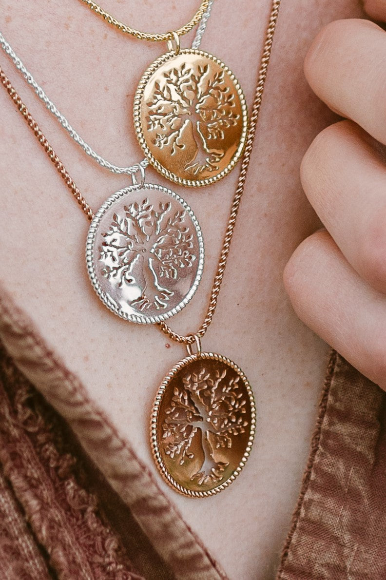 Close up of Rizen Jewelry Rooted Olive Tree Necklace in sterling silver, gold, and rose gold vermeil. 