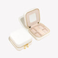 White pebbles leather Rizen Jewelry box with off white velvet interior, featuring a mirror with shell embossed beneath and storage compartment for rings, earrings and bracelet. 