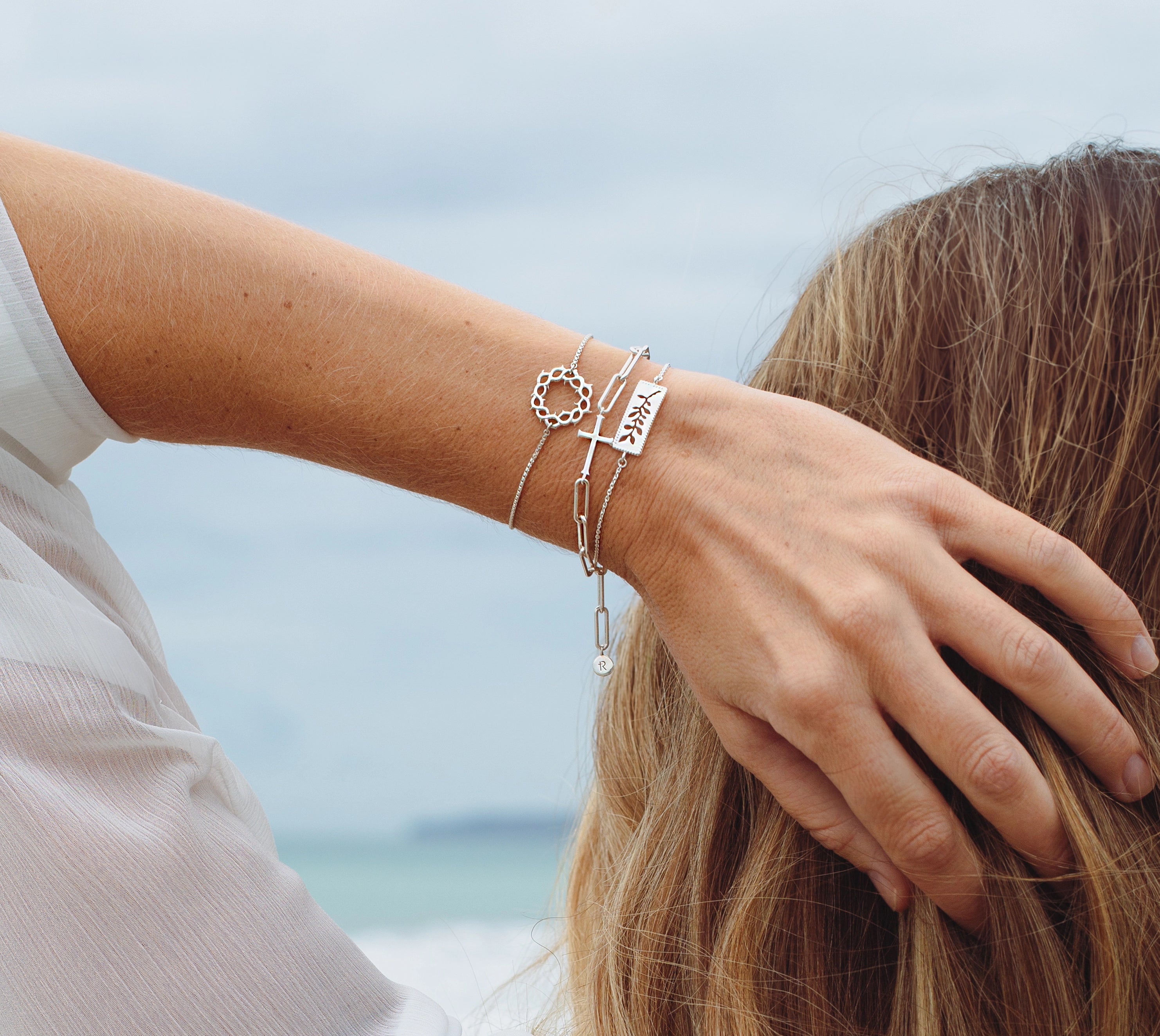 Christian woman wearing faith inspired bracelets by Rizen Jewelry
