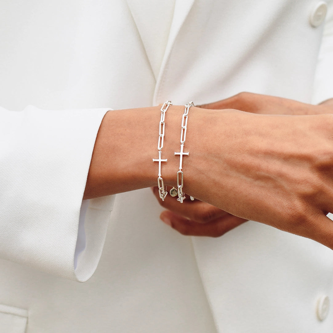 close up of christian woman wearing two silver Chain Breaker Cross Bracelets from the Calvary Collection by Rizen Jewelry.