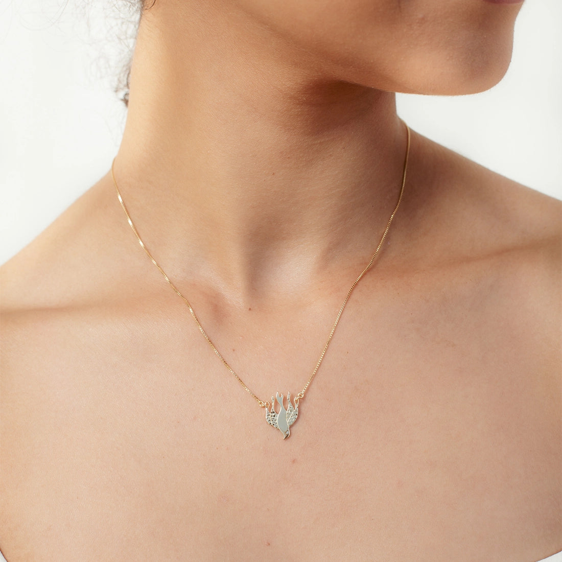 Christian woman wearing the Chispa de la Dove Necklace in 18k gold vermeil from the Chispa Collection by Rizen Jewelry.
