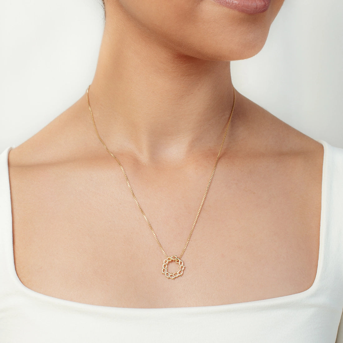 Christian woman wearing gold Crown of Thorns  Necklace from the Insignia Collection by Rizen Jewelry. 