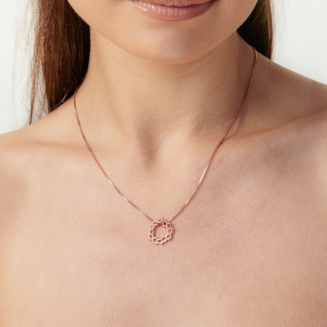 Close up of christian woman wearing the 18k rose gold vermeil crown of thorns necklace from the Insignia Collection by Rizen Jewelry.