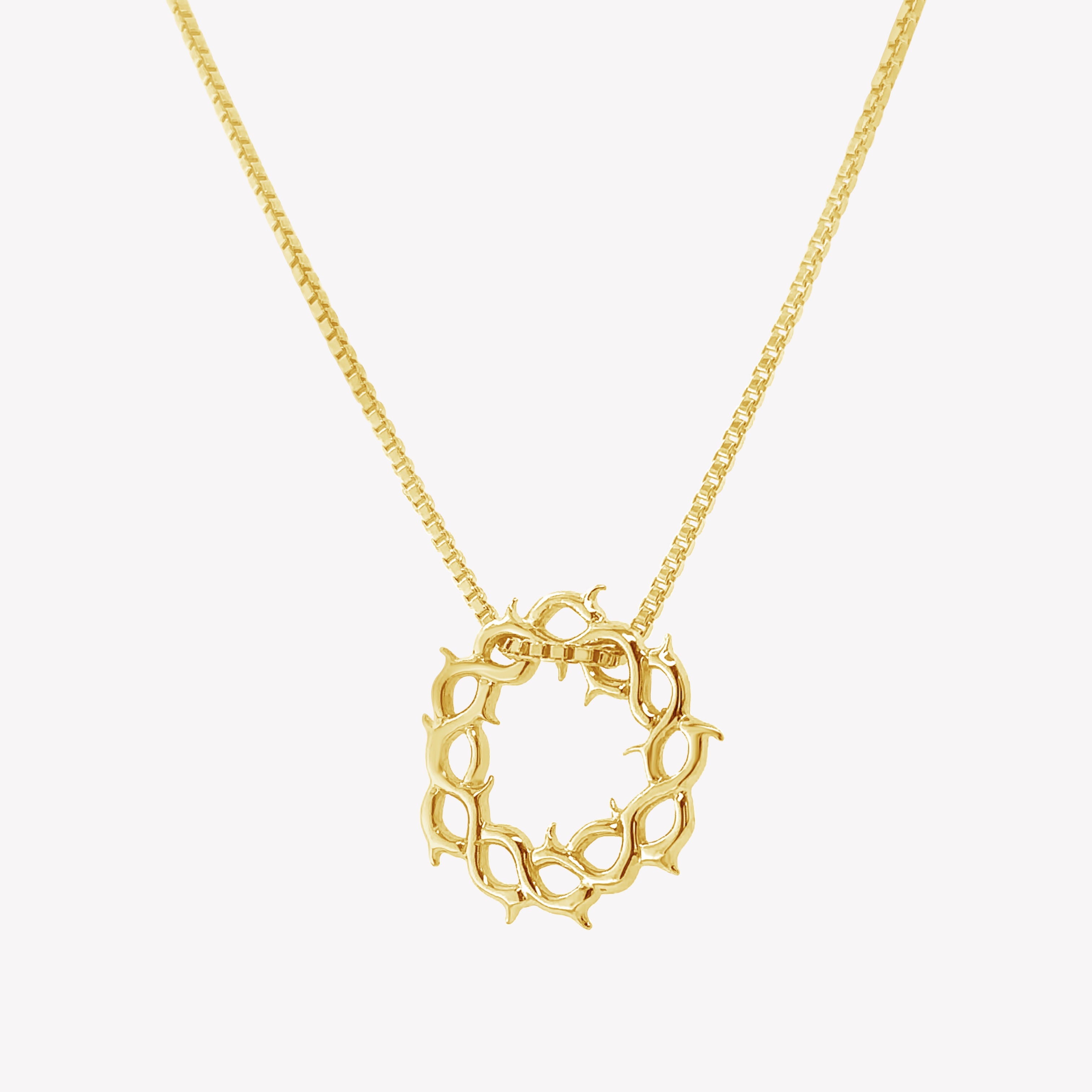 Crown of thorns necklace in gold vermeil by Rizen Jewelry.  Box chain is threaded through faith inspired crown of thorns pendant. 